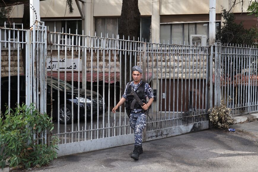 An officer stands guard outside the Justice Palace where Lebanese central bank chief Riad Salameh appeared