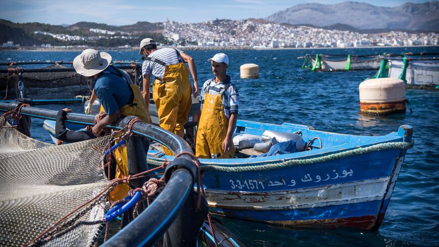 Fisherman work on a fish farm off the coast of Moroccan city of M'diq, on October 3, 2019. - With fish stocks declining in the Mediterranean, struggling Moroccan fisherman are hoping to turn to aquaculture as a way to secure their future. Figures from Morocco's department of maritime fishing confirm the decline. Catches in the eastern Oriental region dropped from 14.7 tonnes to 7.4 between 2013 and 2017. (Photo by FADEL SENNA / AFP) (Photo by FADEL SENNA/AFP via Getty Images)