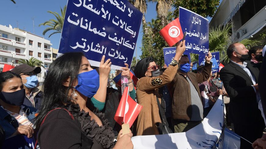 Tunisian employees of travel agencies and the tourism sector demonstrate in front of the Tourism Ministry on October 20, 2020 in Tunis to call for state subsidies in consequence of the Covid-19 pandemic crisis. - Tunisia, which was already battling high unemployment before the start of the pandemic, has seen a record shrinking of its economy. The key tourist industry has all but collapsed, with tourism income plunging 60 percent and swathes of hotels likely to close permanently, officials said last month. (